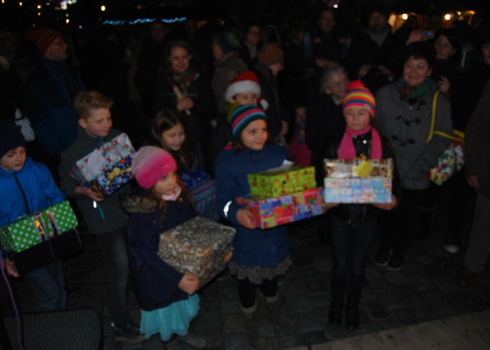 Beim Altstadtweihnachtsmarkt geben die Kinder der Klassen 4 der Grundschule Farrnbach ihre Päckchen ab